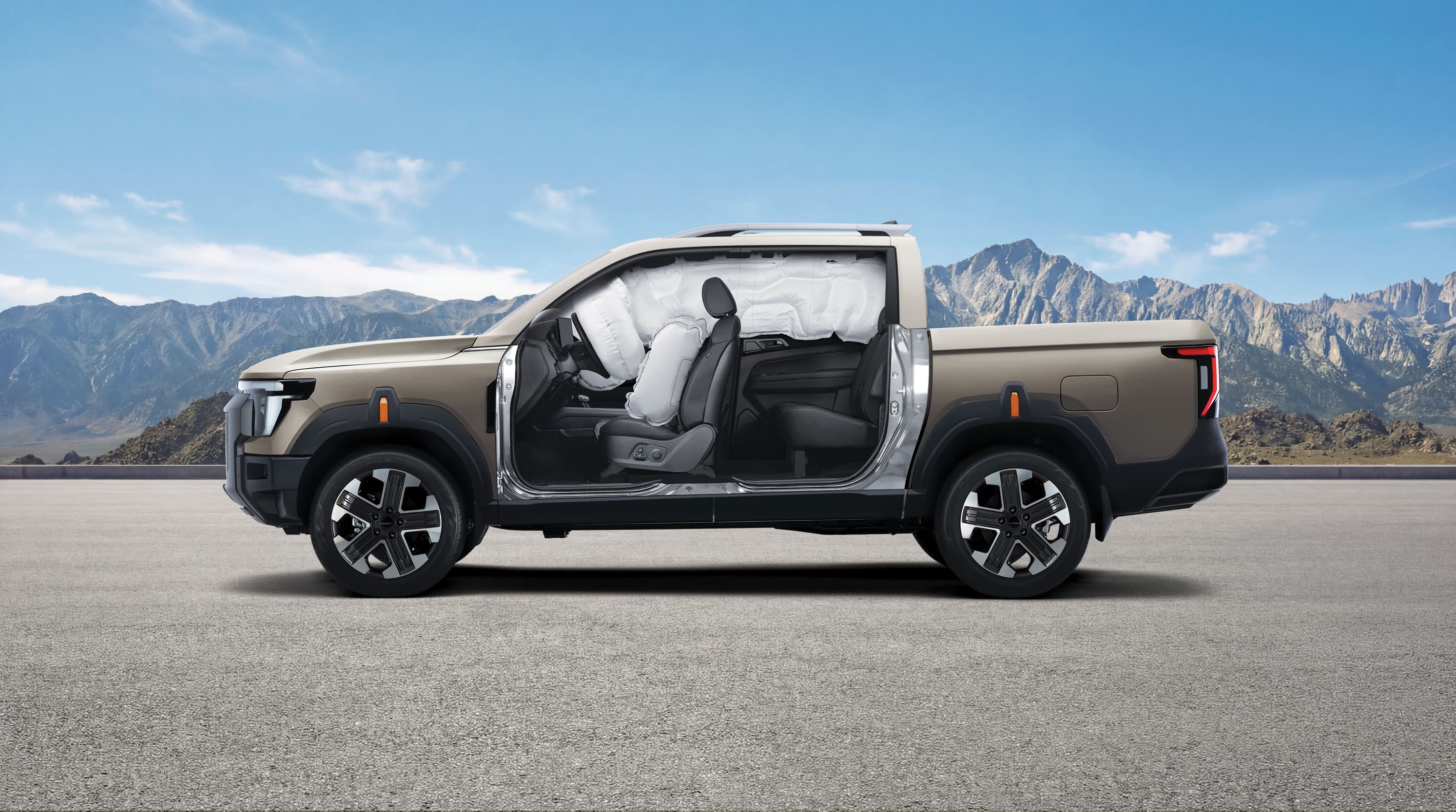 Side view of a beige KGM Musso with airbags deployed, showing interior features, set against a mountainous backdrop under a clear blue sky.