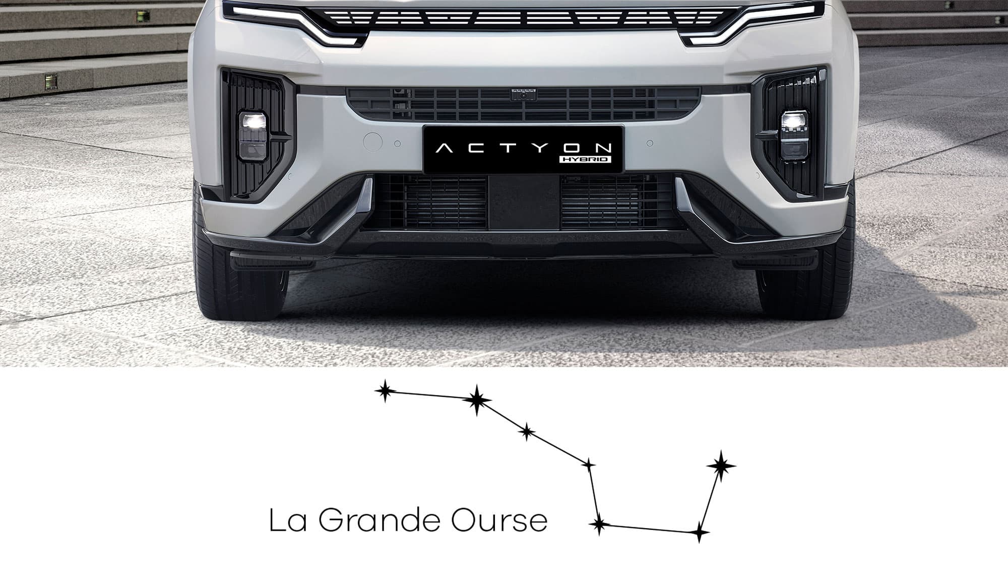 Front view of a white Actyon Hybrid car bumper with license plate above a schematic 'La Grande Ourse' (Big Dipper) constellation graphic.