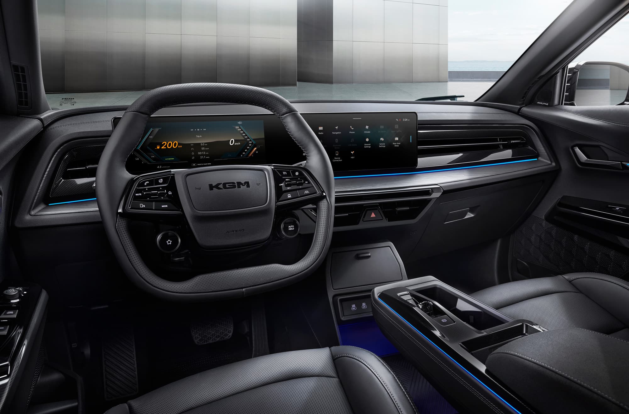 Sleek car interior with leather steering wheel branded "KGM", dual wide digital displays, center console and blue ambient lighting.