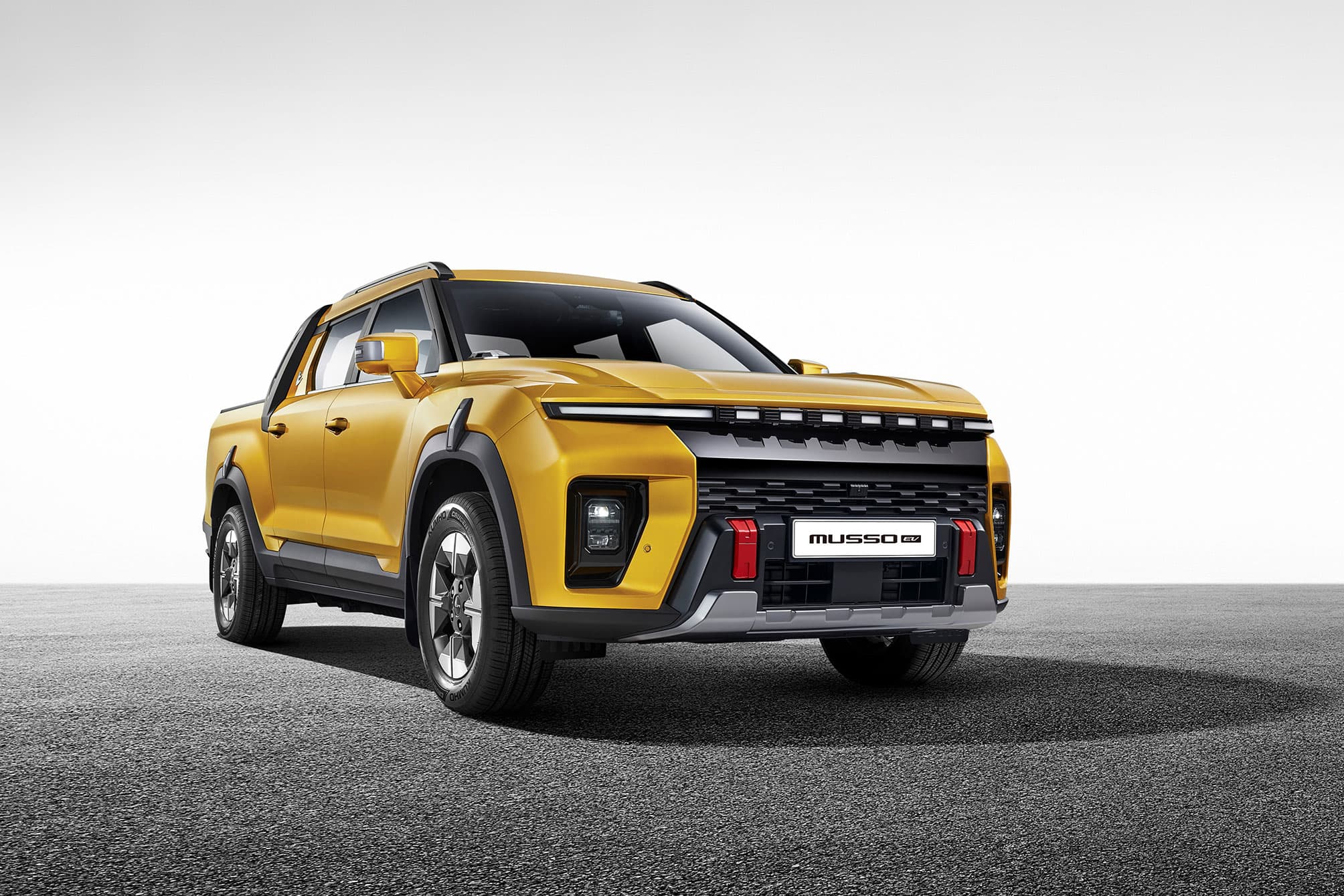 KGM Musso EV yellow on grey background