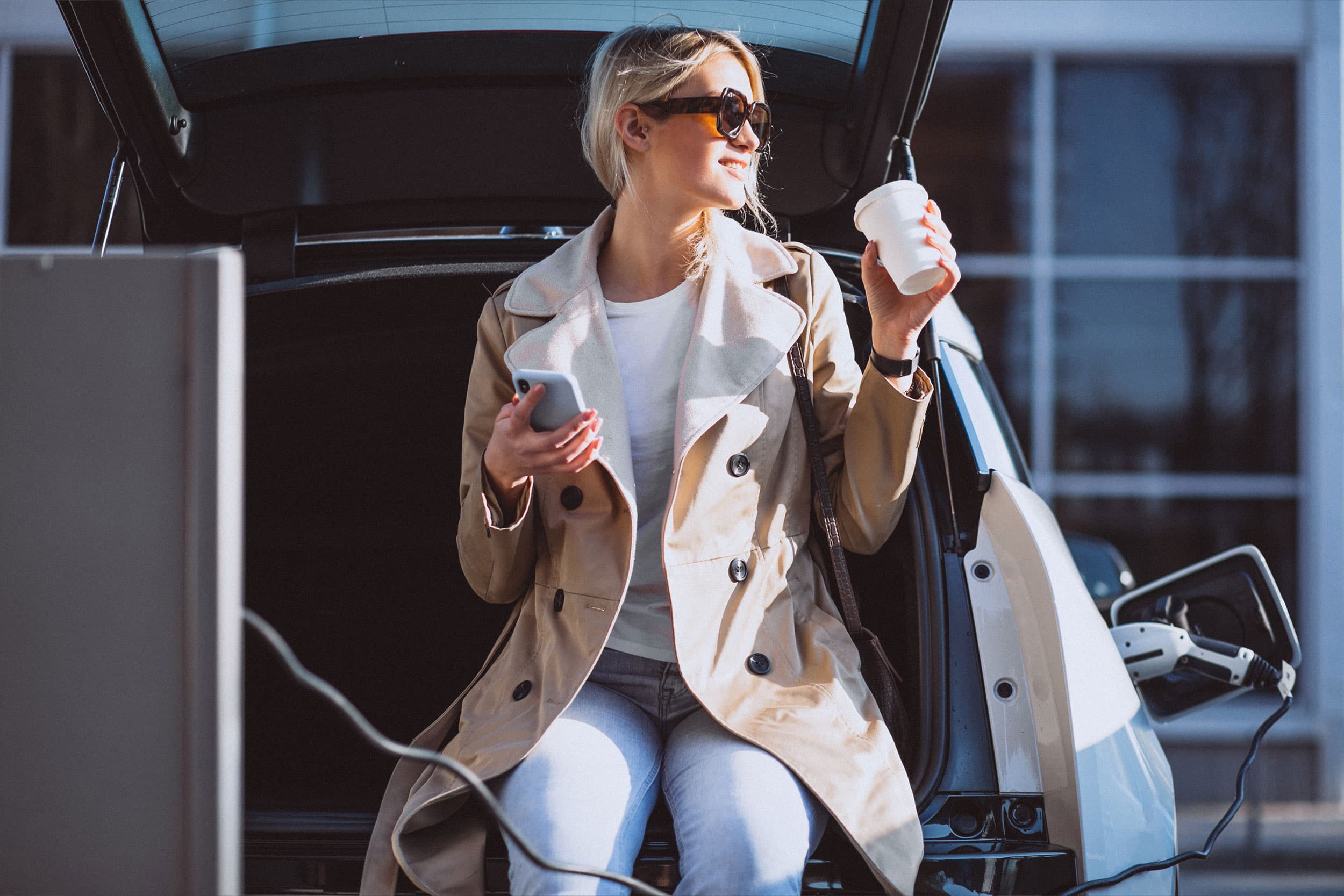 Woman having a break while car is charging